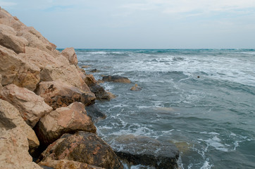 Sea surf during a storm, cloudy weather, gray ocean