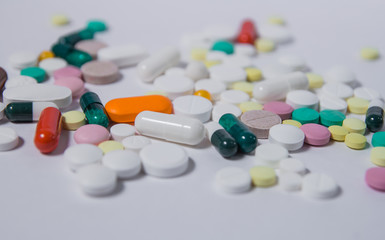 Various medications and vitamins, a pill bottle. Pastel background, place to insert your text....
