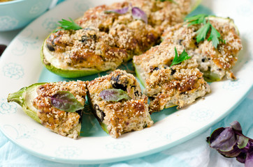 Baked zucchini stuffed with cheese and black olives