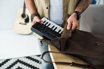 musician putting MPC pad into bag