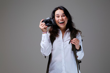 Female tourist with photo camera and travel backpack.