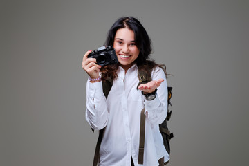 Female tourist with photo camera and travel backpack.