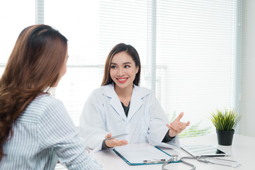 Smiling patient in the doctor's office, she is receiving a prescription medicine