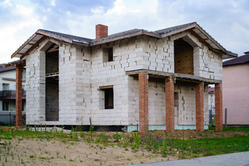 Fototapeta na wymiar Unfinished brick house, still under construction