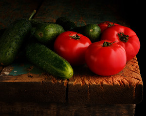 Tomatoes and Cucumber on wooden background