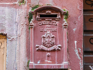 Old red mailbox on the street of Rome, Italy