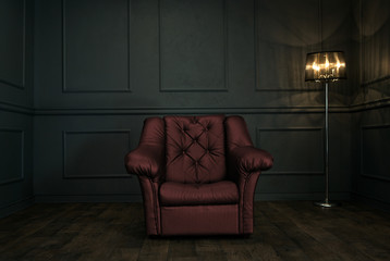 Empty red armchair in elegant dark room with copy space