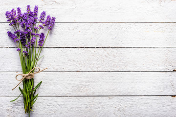 Fresh flowers of lavender bouquet, top view on white wooden background - obrazy, fototapety, plakaty