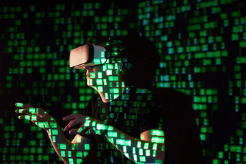 Double exposure of a caucasian man and Virtual reality headset is presumably a gamer or a hacker cracking the code into a secure network or server, with lines of code