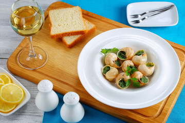 portion of Snails with herbs, butter