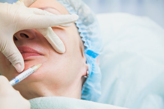 Senior woman cosmetologic injection rejuvenation skin procedure. Adult female patient wrinkle face. Beauty salon