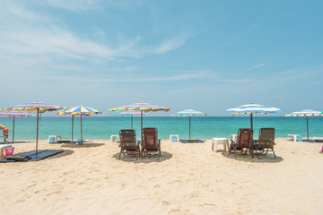 Fototapeta na wymiar Vacation in tropical countries. Beach chairs, umbrella on the beach.