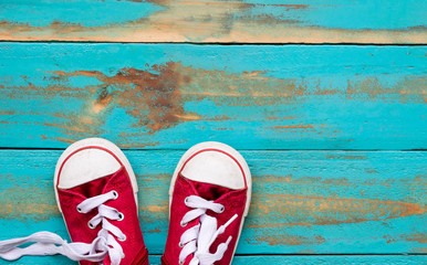 the red sneakers on old blue wooden floor background. copy space for graphic designer