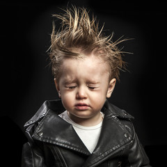 portrait of adorable young boy in leather jacket