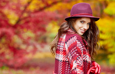 Autumn woman in autumn park with red umbrella, scarf and leather gloves