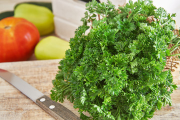 Fresh parsley leaves on rustic wooden cutting board
