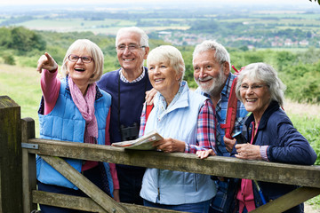 Group Of Senior Friends Hiking In Countryside