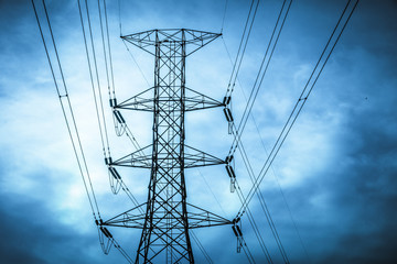 Fototapeta premium Electricity station. Close up high voltage power lines at sunset.
