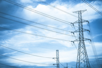 Electricity station. Close up high voltage power lines at sunset.