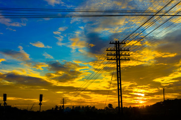 Electricity station. Close up high voltage power lines at sunset.