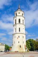 Fototapeta na wymiar Vilnius, Lithuania - August 13, 2017: Beautiful Belfry and Vilnius Cathedral Basilica of Saints Stanislaus and Vladislaus and bright blue sky with clouds, Vilnius Lithuania. Vilnius old town.