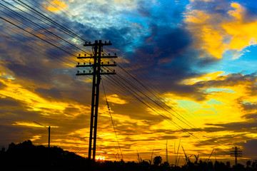 Electricity station. Close up high voltage power lines at sunset.
