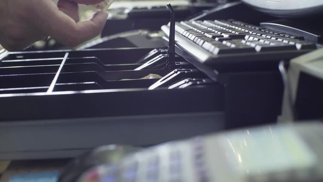 Man's hands opening cash box