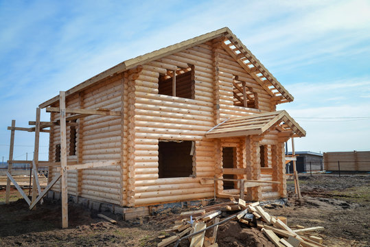 Unfinished, ecological wooden house made of logs in countryside.