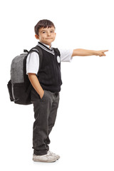 Schoolboy with a backpack pointing