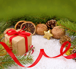 Christmas gift with red ribbon on snow background.