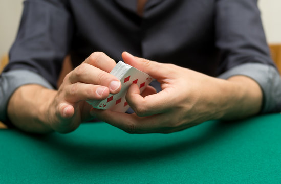 Poker player holding playing cards