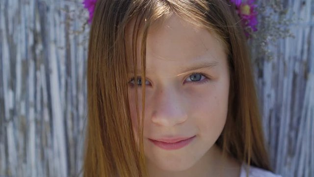 Portrait of little cute girl with pretty eyes on the background. 4K