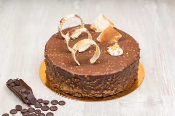 Nut chocolate cake with biscuits rings on the table
