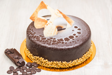 The chocolate glaze cake on the table