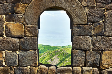 View through the window in brick wall of the medieval armenian fortress Amberd 