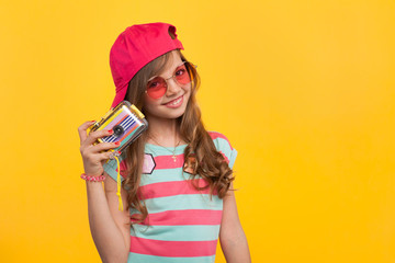 Little hipster girl with photo camera