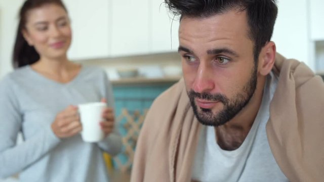 Close up of ill man feeling relief after wife help