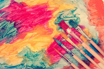 Dirty watercolor brushes and abstract painting