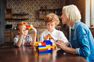 Redhead kid showing car toy to his grandma