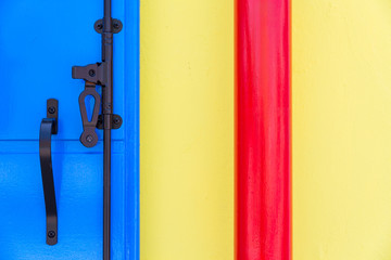 Yellow, blue and red part of the wall with black metal element