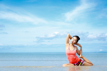 Young woman You are practicing yoga on the beach.