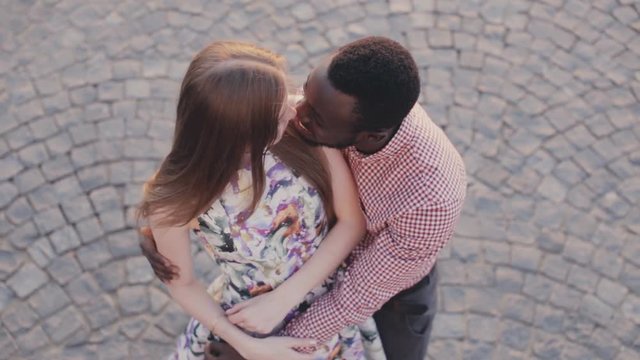 happy interracial couple is kissing