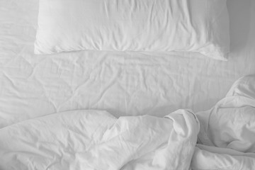 Mattresses blanket and pillows on the luxury bed in the hotel room after a restful sleep.