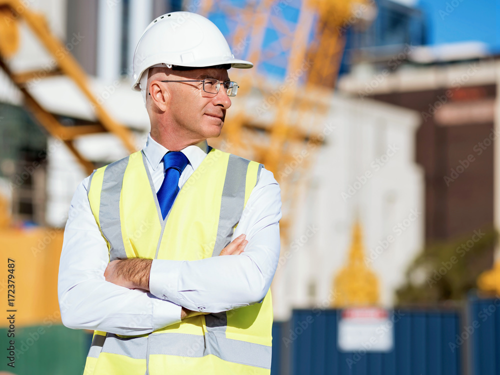 Wall mural Engineer builder at construction site