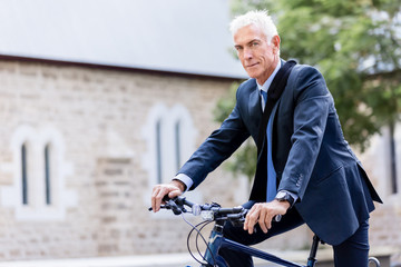 Fototapeta premium Successful businessman riding bicycle