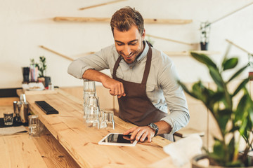 barista using tablet in coffee shop