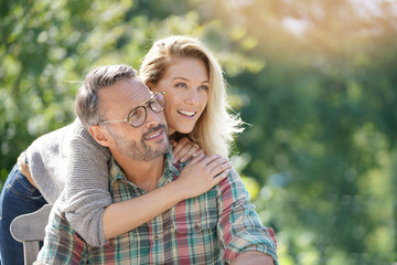 Portrait of mature couple enjoying sunny day in nature