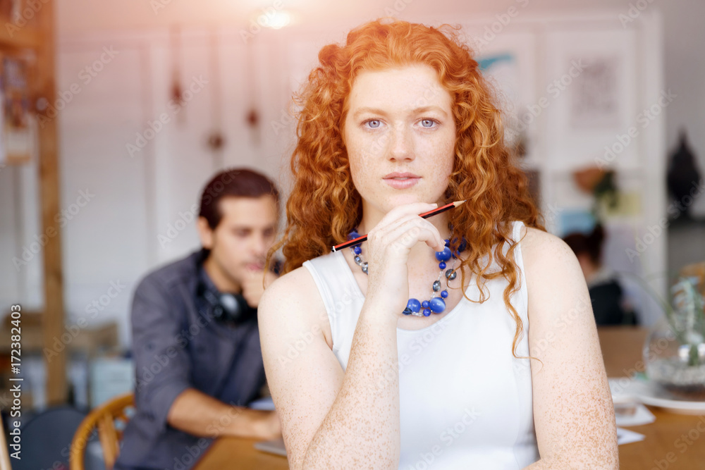 Wall mural Young woman in office