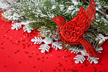 Christmas toys and spruce branches on red background top view