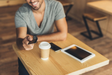 man with credit card in cafe